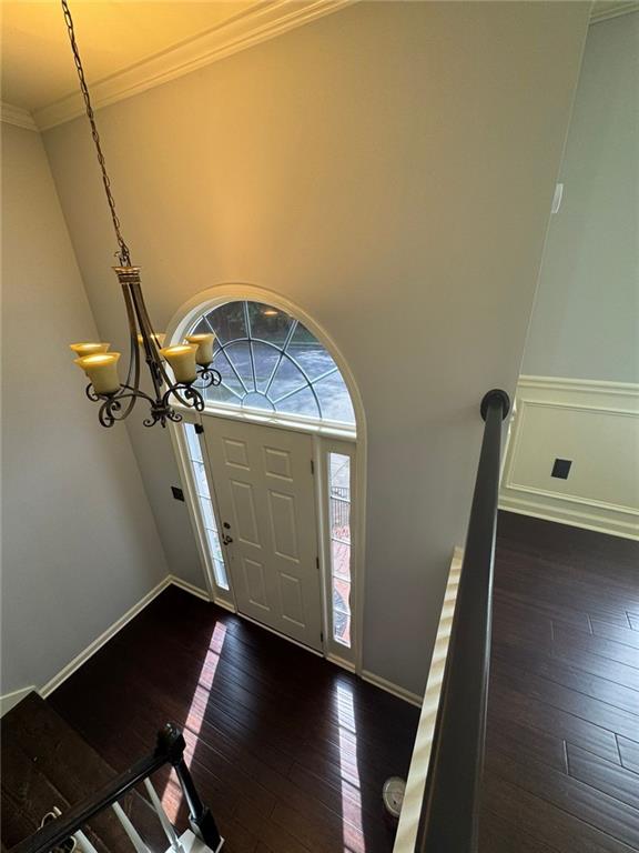 955 Tributary Way, Dacula, GA 30019 - foyer entrance featuring dark wood-style floors, ornamental molding, and a chandelier