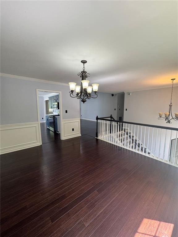 955 Tributary Way, Dacula, GA 30019 - unfurnished room with a chandelier, a wainscoted wall, wood finished floors, and ornamental molding