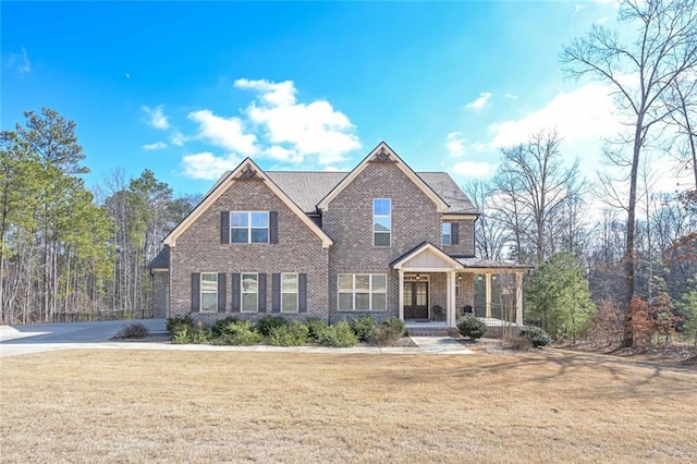 craftsman-style house featuring a front lawn and covered porch