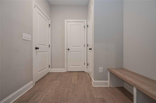 corridor with light wood-type flooring