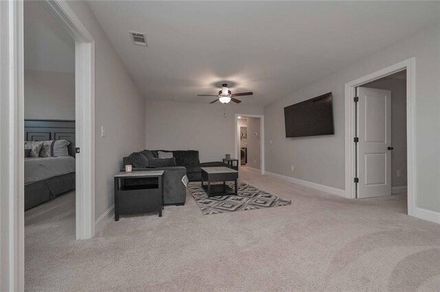 living room with light carpet and ceiling fan