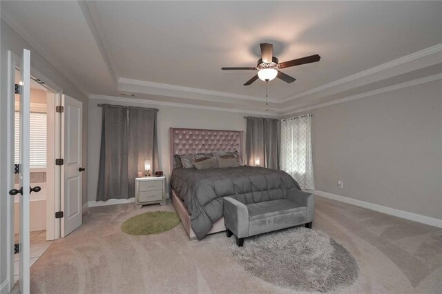 carpeted bedroom with ornamental molding, a raised ceiling, and ceiling fan