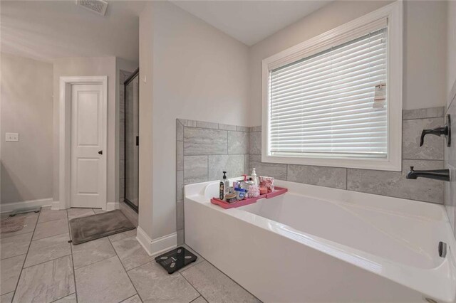 bathroom featuring separate shower and tub and tile patterned flooring