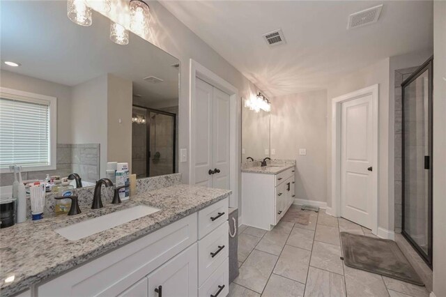 bathroom featuring vanity and a shower with door