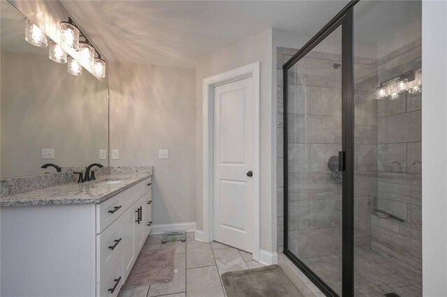 bathroom featuring vanity and a shower with shower door