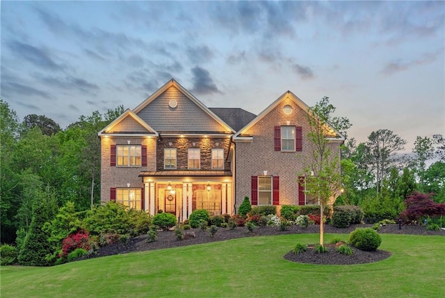 view of front of property with brick siding and a front yard