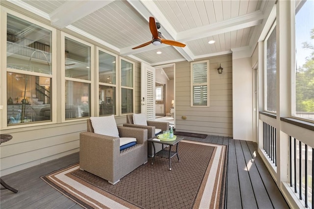 sunroom / solarium featuring ceiling fan, beam ceiling, and a wealth of natural light