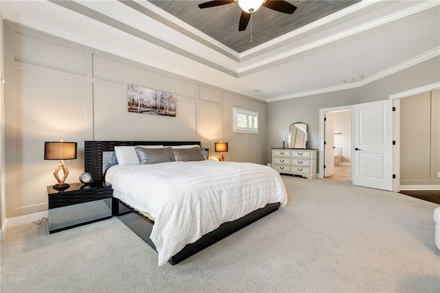 bedroom with baseboards, ornamental molding, carpet, and a tray ceiling