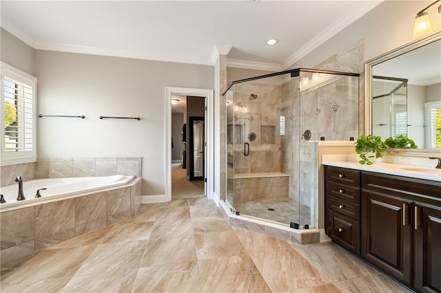 full bath with a healthy amount of sunlight, vanity, ornamental molding, and a garden tub