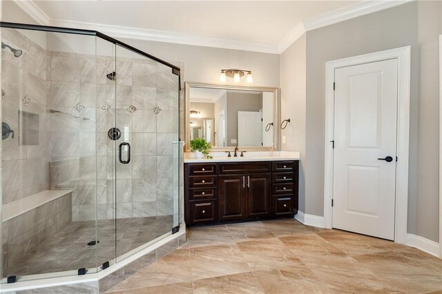 bathroom with crown molding, vanity, baseboards, and a shower stall