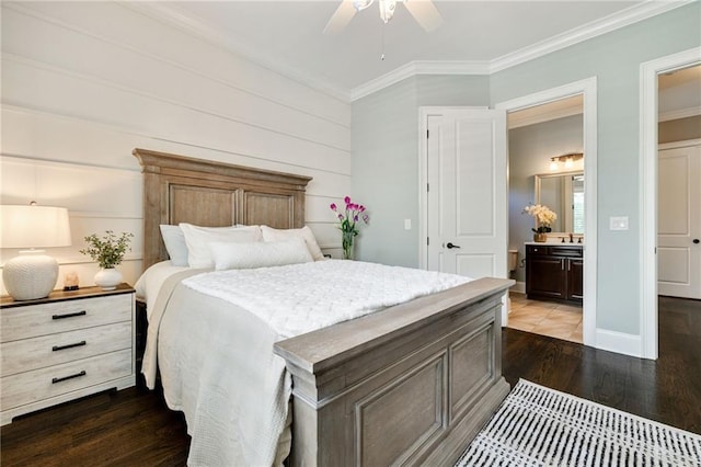 bedroom with ceiling fan, dark wood finished floors, a sink, connected bathroom, and ornamental molding