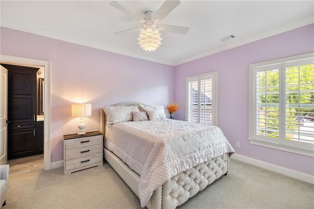 bedroom with crown molding, baseboards, visible vents, and light carpet