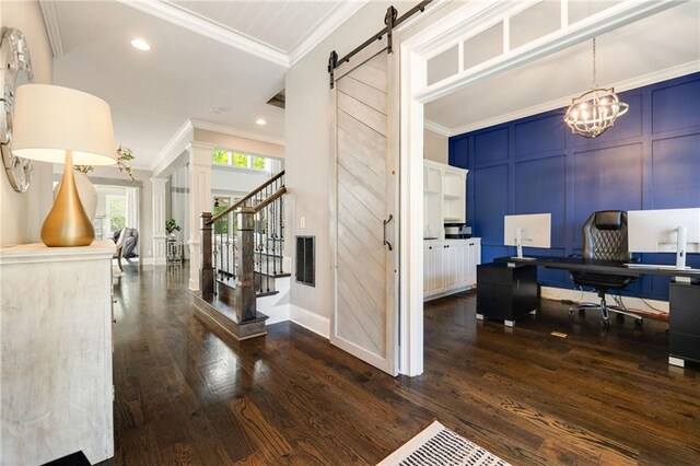 interior space with visible vents, ornamental molding, dark wood-style flooring, a decorative wall, and a barn door