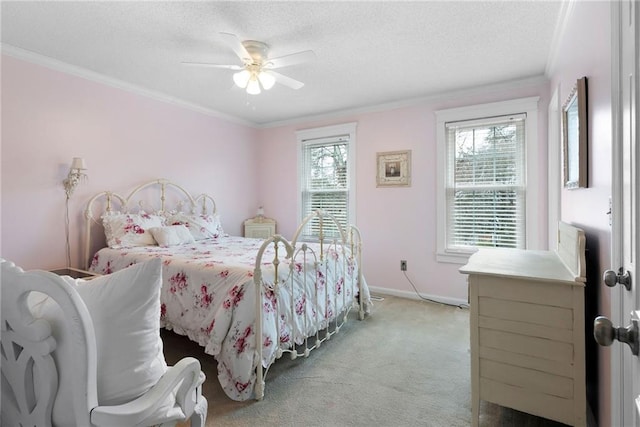 bedroom with light colored carpet, crown molding, a textured ceiling, and baseboards