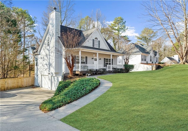 view of front facade featuring a porch, a garage, and a front lawn