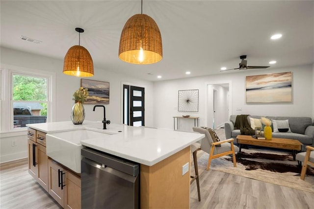 kitchen with light wood-type flooring, dishwasher, open floor plan, and visible vents