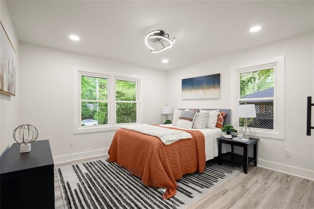 bedroom featuring recessed lighting, baseboards, and light wood-style floors