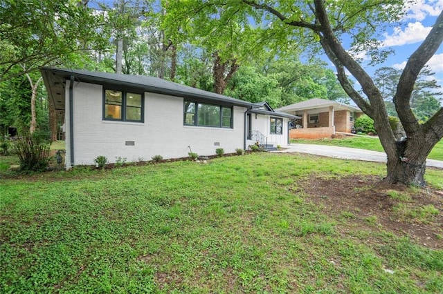 ranch-style house with a front yard, crawl space, concrete driveway, and brick siding
