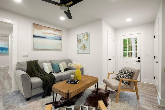 living room featuring a ceiling fan, light wood finished floors, recessed lighting, and baseboards