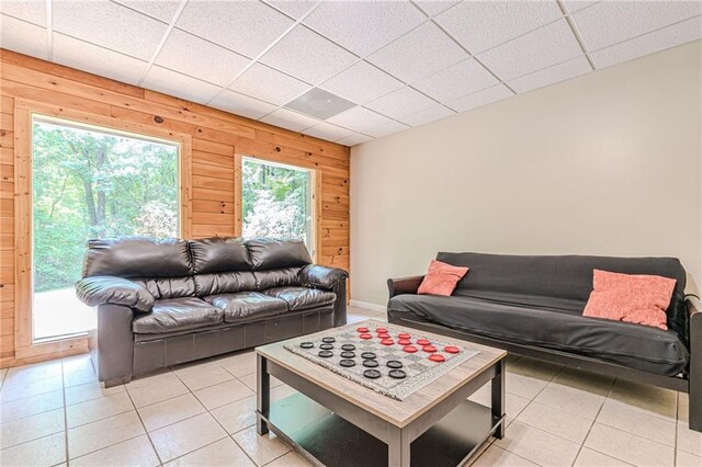 45 Chestatee River Rdg NE, Dahlonega, GA 30533 - living room featuring light tile patterned floors, wood walls, baseboards, and a paneled ceiling