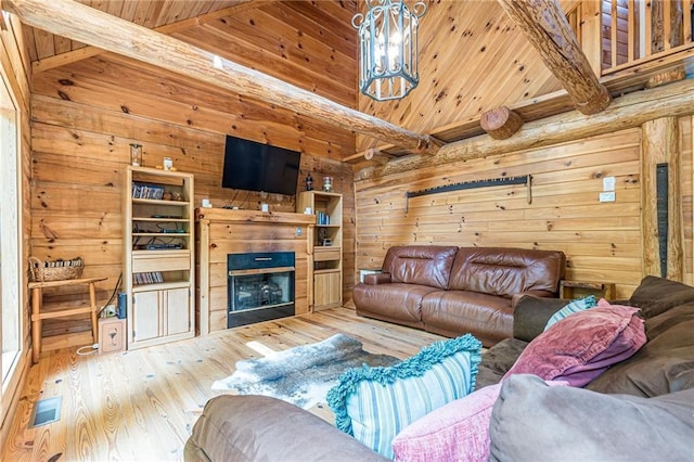 45 Chestatee River Rdg NE, Dahlonega, GA 30533 - living room featuring wood-type flooring, wooden walls, a fireplace, a chandelier, and wood ceiling