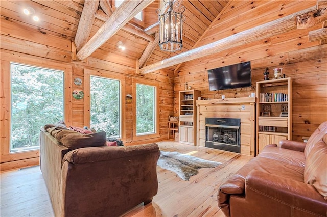 45 Chestatee River Rdg NE, Dahlonega, GA 30533 - living room featuring wood walls, hardwood / wood-style floors, wood ceiling, a chandelier, and a fireplace