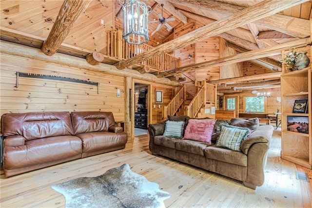 45 Chestatee River Rdg NE, Dahlonega, GA 30533 - living room featuring a chandelier, wood walls, high vaulted ceiling, hardwood / wood-style flooring, and stairway