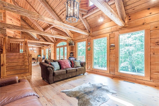 45 Chestatee River Rdg NE, Dahlonega, GA 30533 - living area with wooden ceiling with exposed beams, hardwood / wood-style floors, wooden walls, stairs, and a chandelier