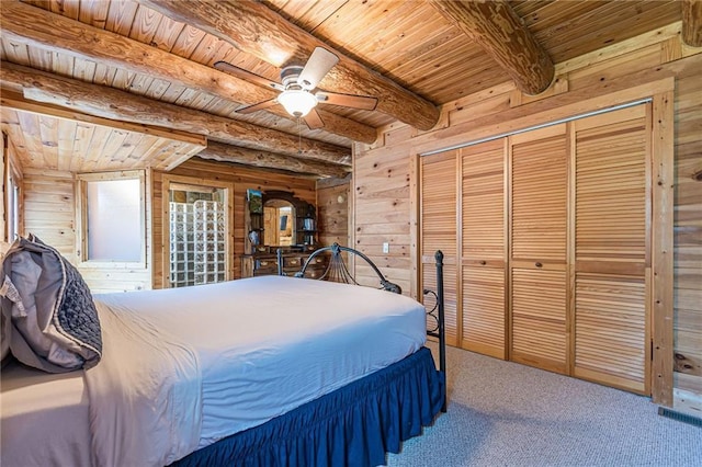 45 Chestatee River Rdg NE, Dahlonega, GA 30533 - carpeted bedroom with wooden ceiling with exposed beams, wood walls, a closet, and ceiling fan
