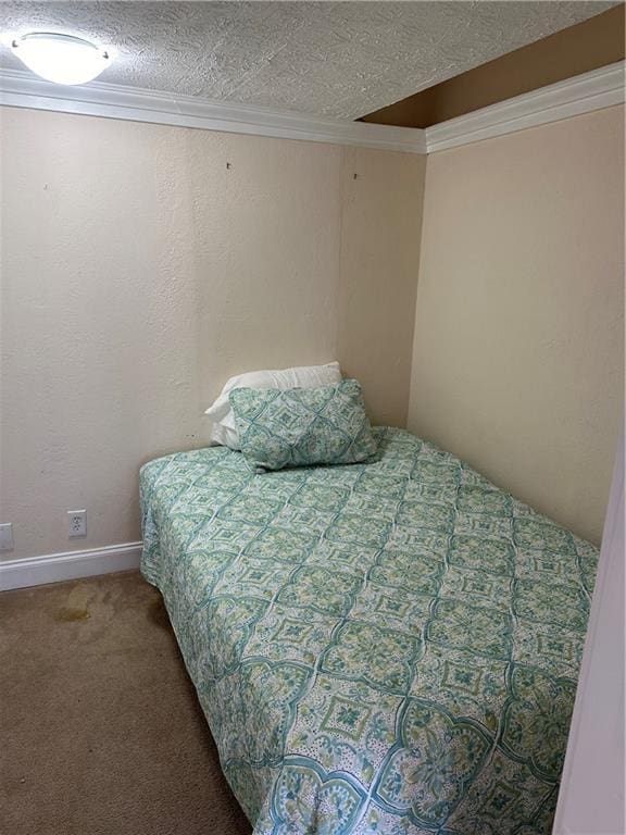 carpeted bedroom featuring a textured ceiling and ornamental molding