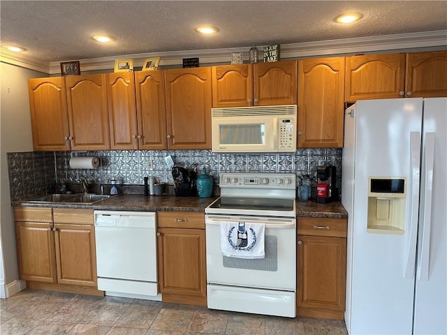 kitchen featuring dark countertops, decorative backsplash, brown cabinetry, a sink, and white appliances