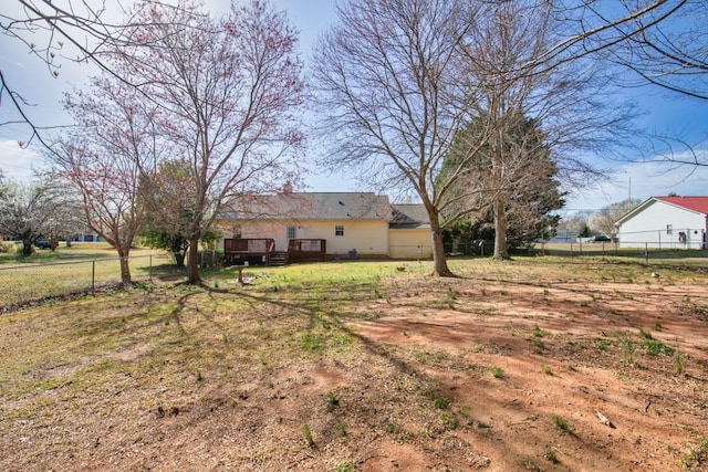 view of yard featuring a wooden deck and fence