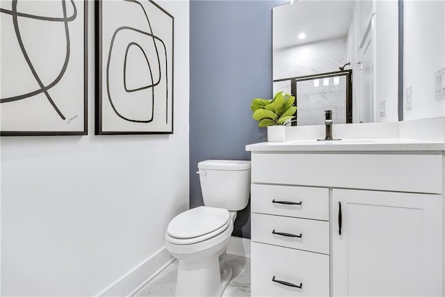 bathroom with an enclosed shower, vanity, and toilet