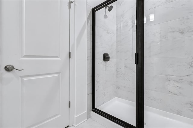 bathroom featuring a shower with door