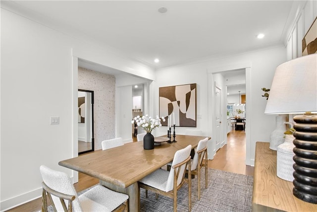 dining room featuring crown molding and wood-type flooring