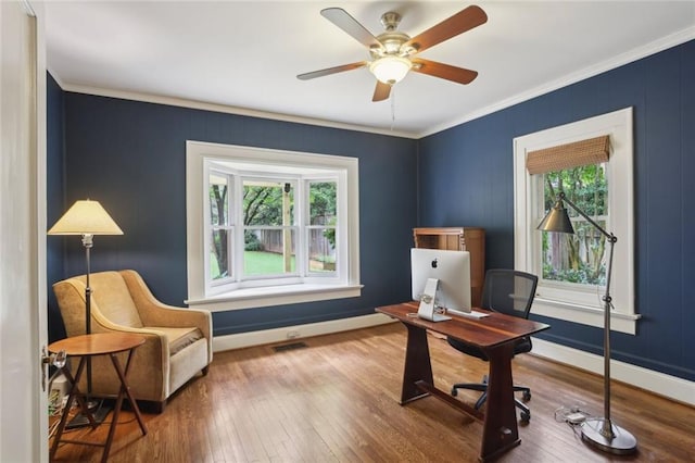 office with crown molding, wood finished floors, baseboards, and ceiling fan