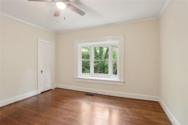 unfurnished room with wood finished floors, a ceiling fan, crown molding, and baseboards