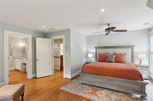 bedroom with light wood-type flooring, baseboards, recessed lighting, ceiling fan, and ensuite bathroom
