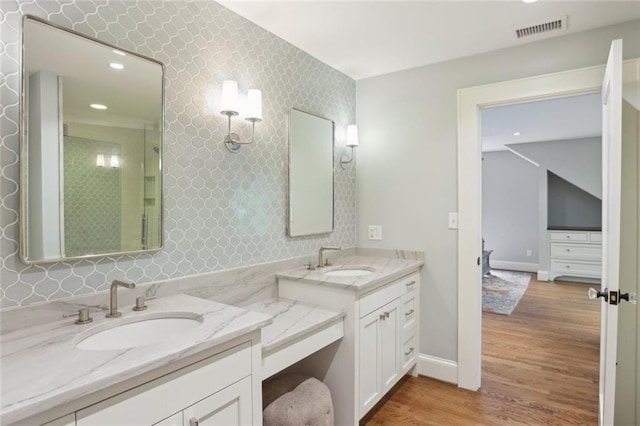 full bath with a stall shower, wood finished floors, vanity, recessed lighting, and baseboards