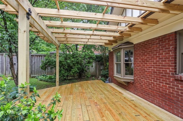 wooden deck with a fenced backyard and a pergola