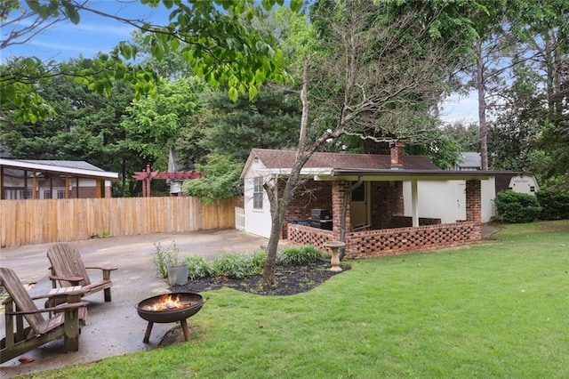 view of yard featuring an outdoor fire pit and a patio area