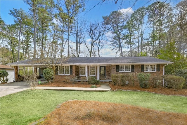 single story home featuring driveway, a front lawn, a carport, and brick siding