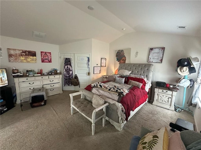 carpeted bedroom with lofted ceiling and a closet