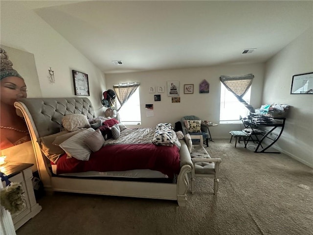 bedroom featuring lofted ceiling and dark colored carpet