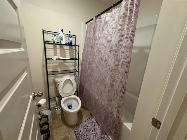 bathroom featuring tile patterned flooring, toilet, and shower / bath combo