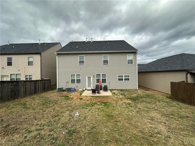 rear view of house with cooling unit, a yard, and a patio area