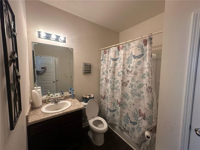 full bathroom with vanity, shower / bath combo with shower curtain, and toilet