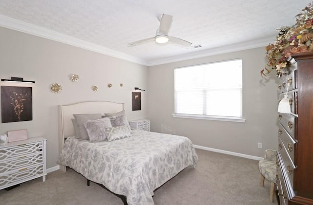carpeted bedroom featuring baseboards, visible vents, a ceiling fan, and crown molding