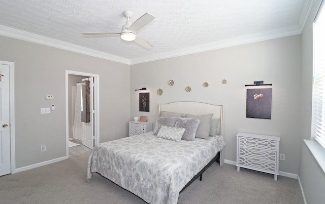 carpeted bedroom with baseboards, ornamental molding, and a ceiling fan