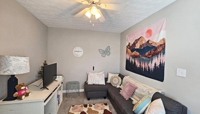carpeted living area with a textured ceiling, a ceiling fan, and baseboards